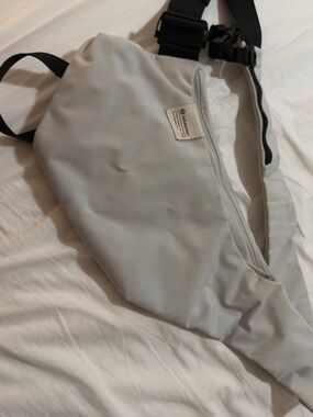 lululemon athletica light gray sling bag with black strap